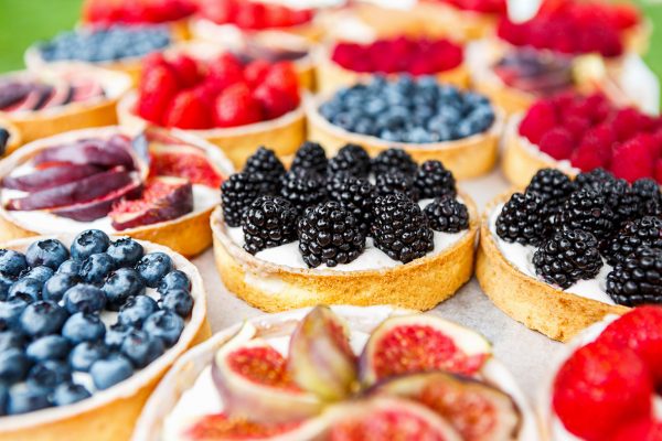 Using Flavours for Baking. A display of tarts with various fruit toppings.